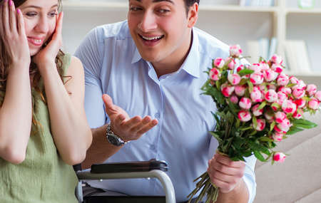 Man making marriage proposal to disabled woman on wheelchairの写真素材