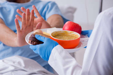 Male patient eating food in the hospital