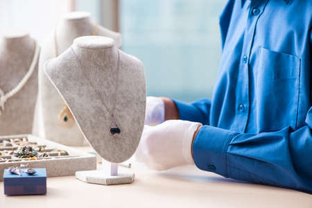 Young jeweler working in his workshopの写真素材