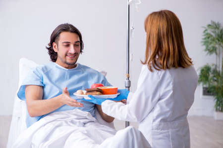 Male patient eating food in the hospitalの写真素材