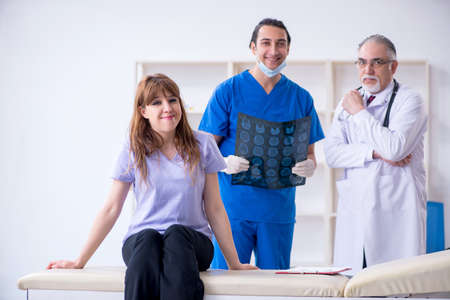 Two doctors examining young woman