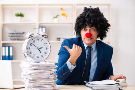 Young clown businessman working in the officeの写真素材