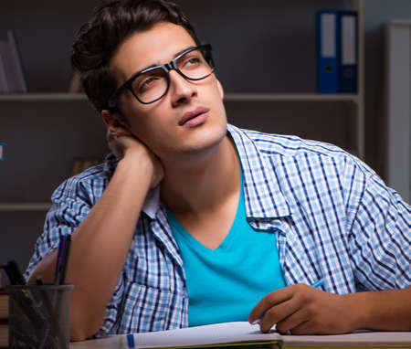 Student preparing for exams late night at homeの写真素材