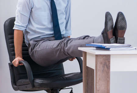 Businessman doing sports in office during break