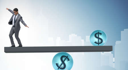 Businessman balancing in financial dollar conceptの写真素材