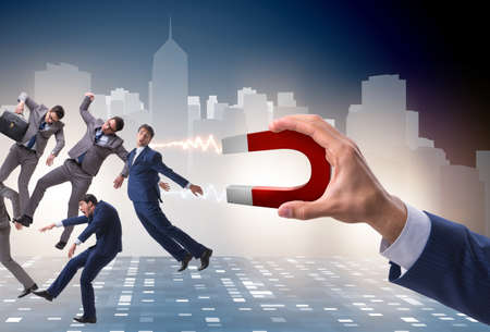 Businessman in recruitment concept with horseshoe magnetの写真素材