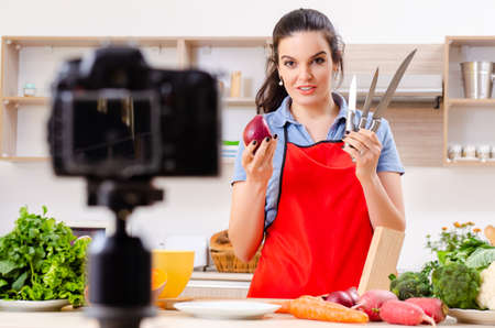 Young female vegetarian recording video for her blogの写真素材