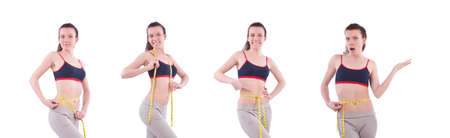 Young girl with centimeter in dieting conceptの写真素材