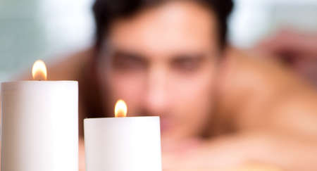 The young handsome man during spa procedureの写真素材