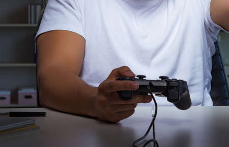The young man playing games long hours late in the office