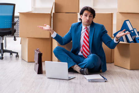 Young handsome businessman moving to new workplaceの写真素材