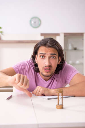Young male student preparing for exams at homeの写真素材