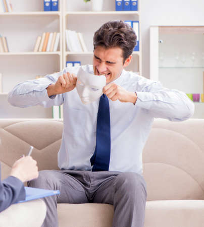 Young man visiting psychiatrist doctor for consultationの写真素材