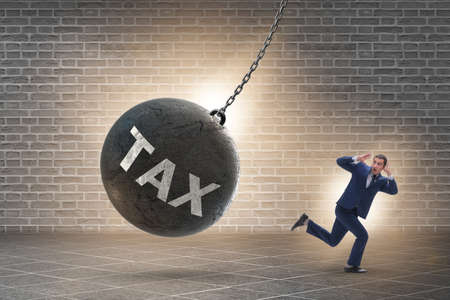 Businessman running away from high taxesの写真素材