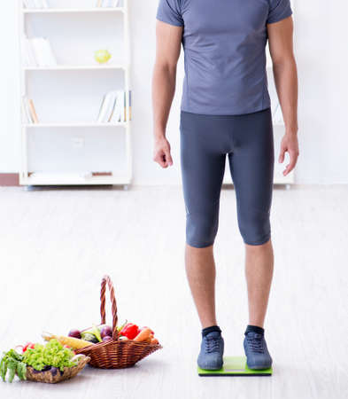 The man promoting the benefits of healthy eating and doing sportsの写真素材