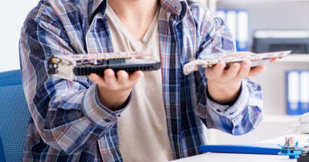The professional repairman repairing computer in workshop