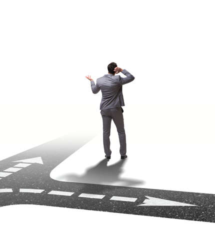 The young businessman at crossroads in uncertainty conceptの写真素材