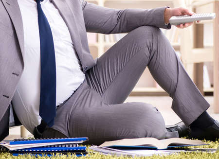 The businessman working on the floor at homeの写真素材