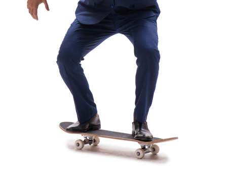 The businessman riding skateboard isolated on white backgroundの写真素材