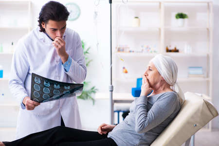 Young male doctor and female oncology patient