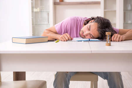 Young male student preparing for exams at homeの写真素材