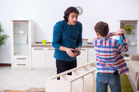 Young carpenter teaching his sonの写真素材