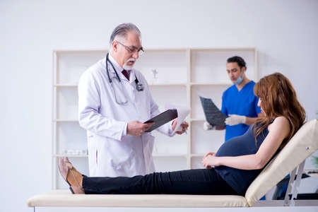 Two doctors examining young woman
