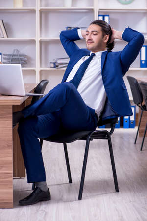 Young handsome businessman working in the officeの写真素材