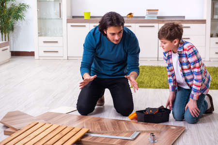 Young carpenter teaching his sonの写真素材