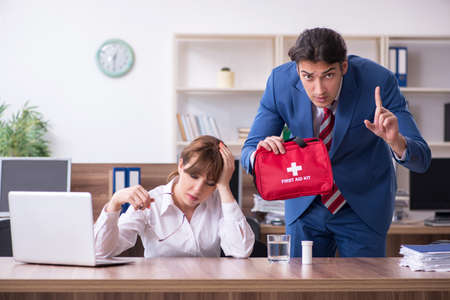 Young employee suffering in the officeの写真素材