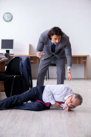 Male employee suffering from heart attack in the officeの写真素材