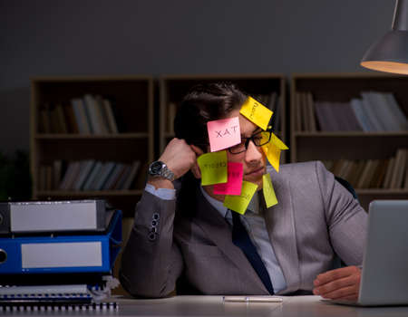 Businessman staying late to sort out prioritiesの写真素材