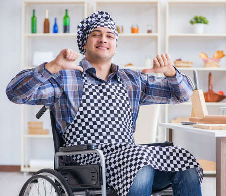 Disabled young man husband working in kitchenの写真素材