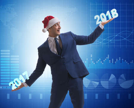 Businessman in santa hat holding 2017 and 2018の写真素材