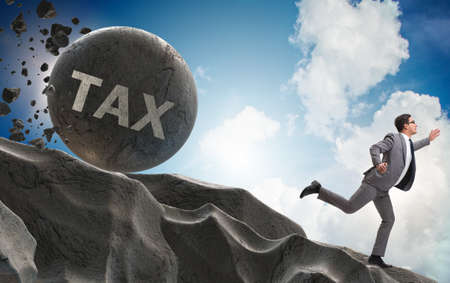 Businessman in high taxes business conceptの写真素材
