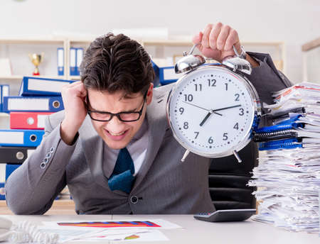 Businessman missing deadlines due to excessive workの写真素材