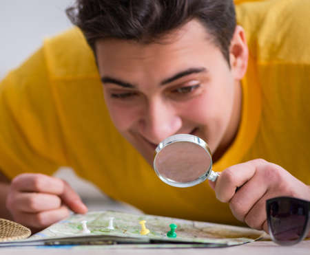 Man planning his vacation trip with mapの写真素材