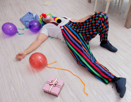 Drunk clown celebrating having a party at homeの写真素材