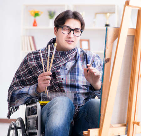 Disabled artist painting picture in studioの写真素材