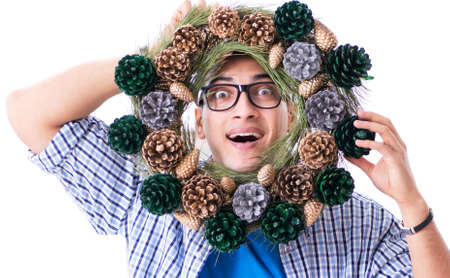 Young man making christmas decoration from conesの写真素材