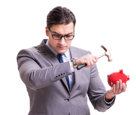 Businessman breaking piggy bank isolated white backgroundの写真素材