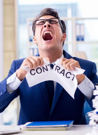 Businessman with message in the office at deskの写真素材