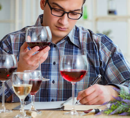 Professional sommelier tasting red wineの写真素材
