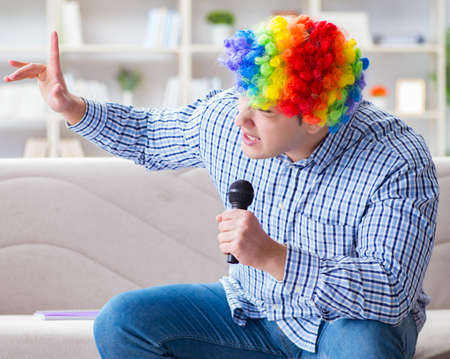 Funny man singing songs in karaoke at homeの写真素材