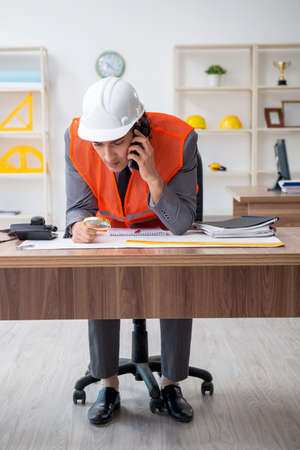Young male architect working in the office