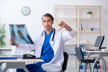 Young male doctor working in the clinicの写真素材