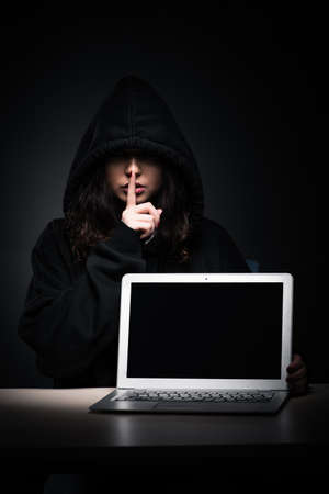 Female hacker hacking security firewall late in officeの写真素材