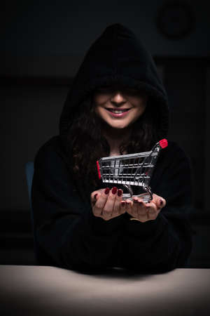 Female hacker hacking security firewall late in officeの写真素材