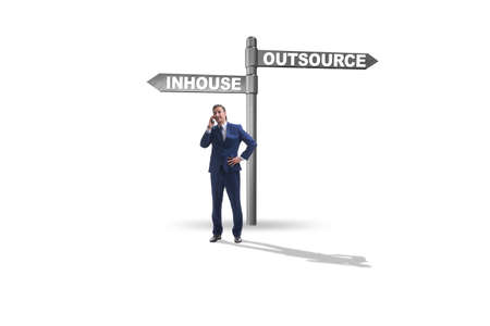 Businessman at crossroads deciding between outsourcing and inhouseの写真素材
