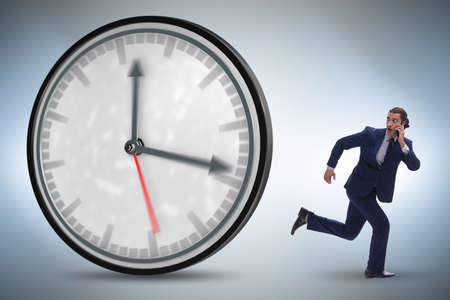 Businessman employee in time management conceptの写真素材